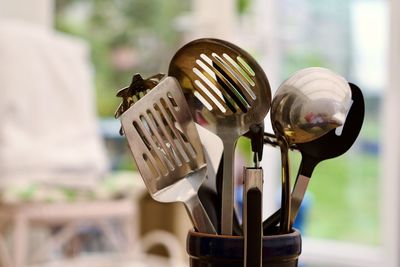 Close-up of a pot of cooking utensils against a bokeh background