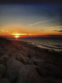 Scenic view of beach against sky during sunset