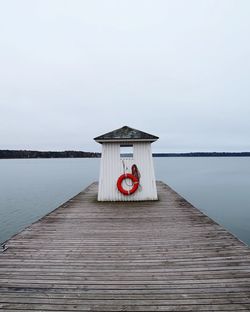 Pier over lake against clear sky
