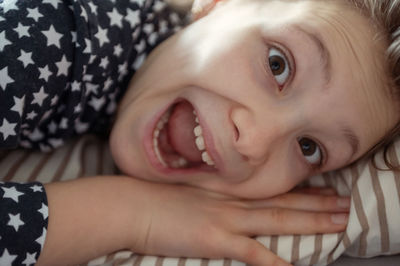 Portrait of cute girl lying on bed