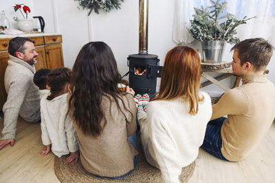 Rear view of mother and daughter at home