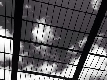 Low angle view of modern building against cloudy sky