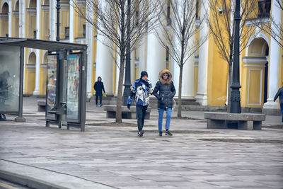 People walking on sidewalk in city