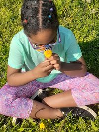 Full length of a girl sitting on field