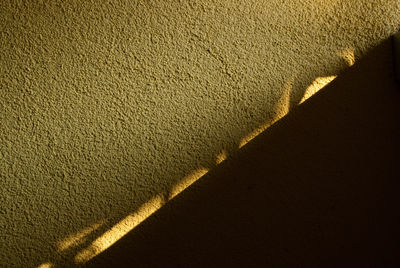 High angle view of sunlight falling on wall