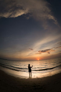 Fish-eye view of sea against sky at beach