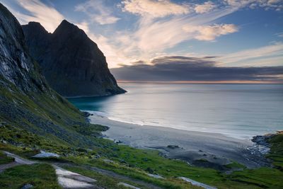 Scenic view of sea and mountains against sky