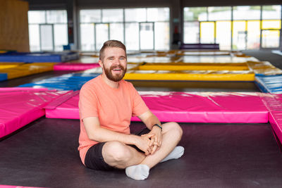 Portrait of smiling young man sitting at home