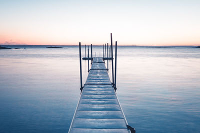 Pier over sea against clear sky