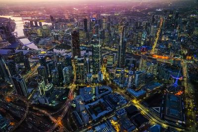 High angle view of city lit up at night