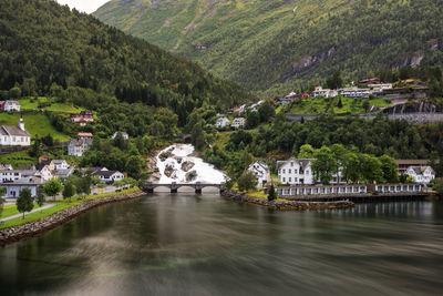 Scenic view of river by buildings in city