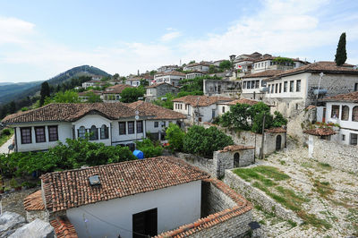 Buildings in town against sky