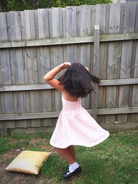 Rear view of girl standing on field