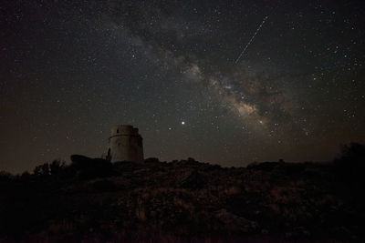 Milky way over an old watchtower