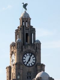 Low angle view of clock tower against sky