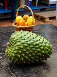 Basket of typical colombian fruits with guanabana fruit in front