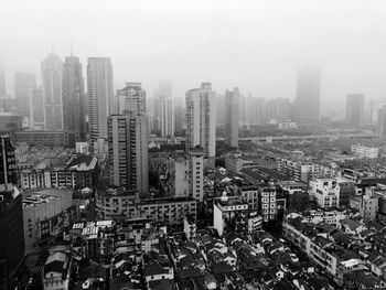 High angle view of modern buildings in city against sky