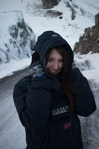 Portrait of woman standing in snow