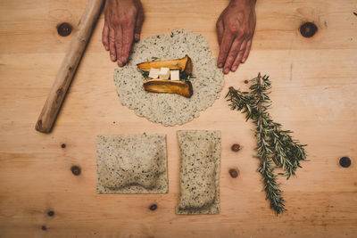 Directly above shot of hands preparing food on table