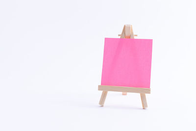 Close-up of toy on chair against white background