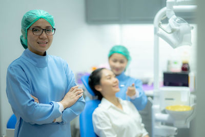 Portrait of female friends standing in laboratory