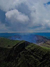 Scenic view of landscape against cloudy sky