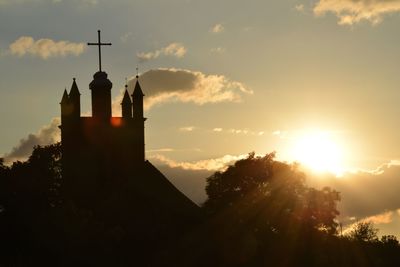 Low angle view of built structure against sky at sunset