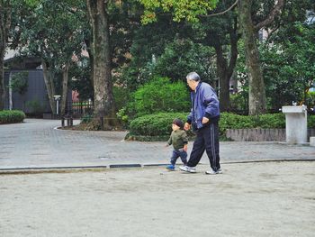 Full length of father and son on tree