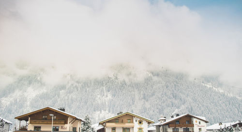 Houses against sky during winter