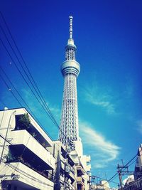 Low angle view of tower against blue sky