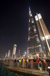 Crowd outside illuminated burj khalifa