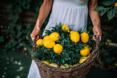 Midsection of woman holding basket