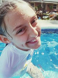 Close-up portrait of cute girl in swimming pool