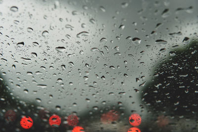 Raindrops on glass window during rainy season