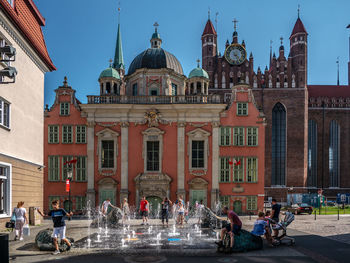 Group of people in front of buildings in city