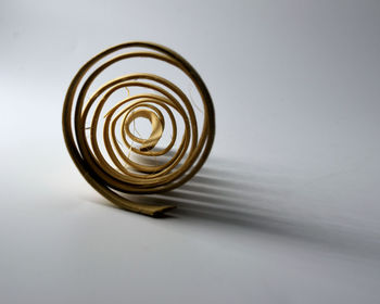 Close-up of spiral object over white background