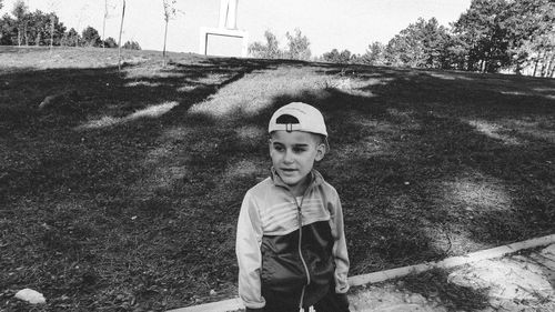 Boy standing on footpath at park