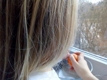 Girl having fruit in car