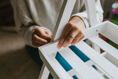 Close-up of hand holding paper at home