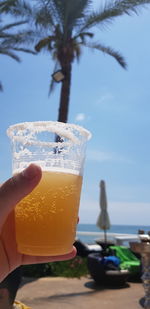 Close-up of hand holding beer glass