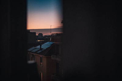 Silhouette building against sky during sunset