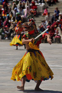 Woman dancing on street during festival