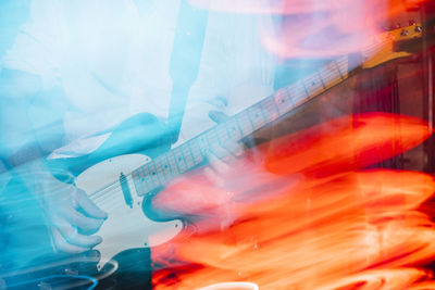 Blurred motion of playing guitar