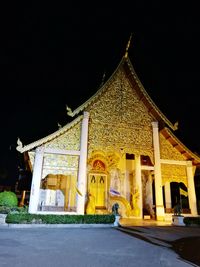 Temple against clear sky at night