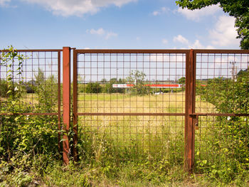 Fence on field against sky