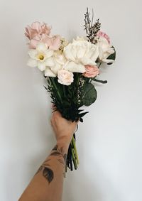 Cropped hand of woman holding bouquet