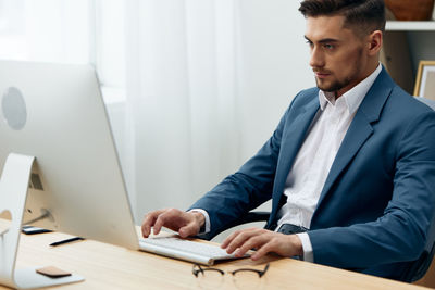 Young man using laptop at home