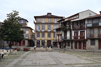 Street amidst buildings in town against sky