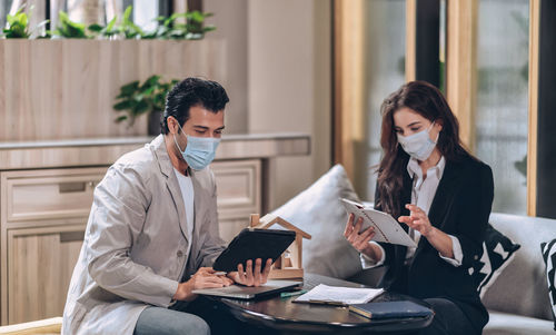 Real estate sale agent team working together during pandemic in office