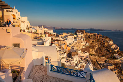 Tourists looking at the amazingly beautiful sunset at la caldera in oia city in santorini island